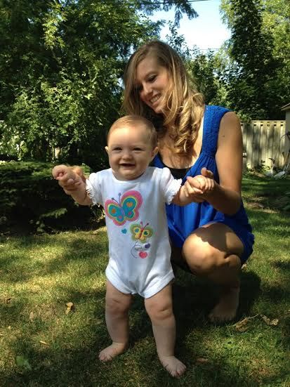 Nanny playing with baby in backyard