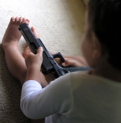 Child Playing With Gun